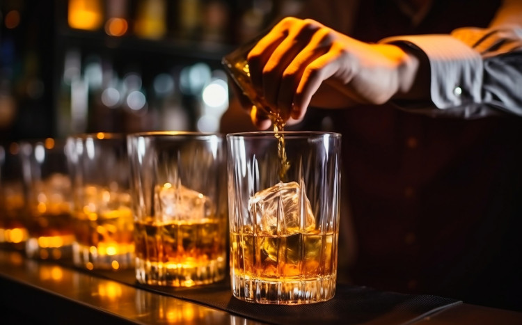 Barman nalewa whisky do szklanki