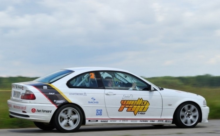 Białe BMW z hasłami reklamowymi na boku karoserii