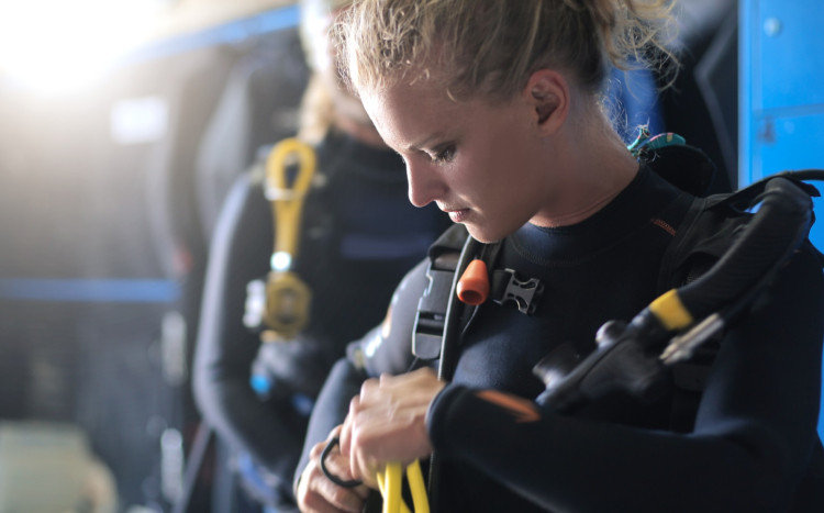 kobieta zakłada str&oacutej do nurkowania