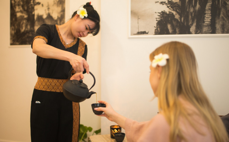 masażystka polewa herbatę balijską