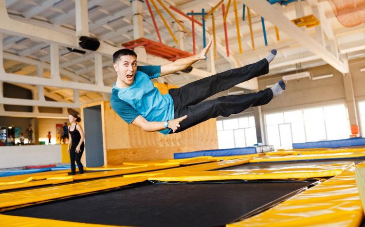 mężczyzna bawiący się w parku trampolin